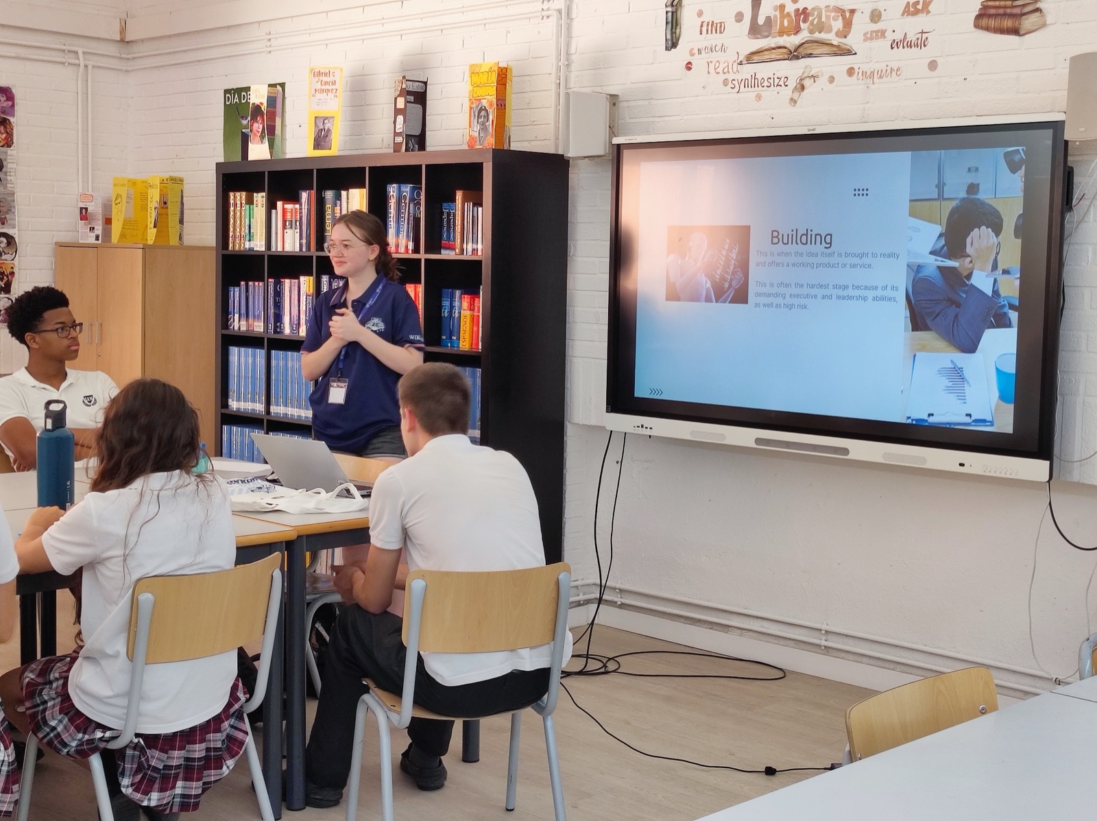Students watching a Wikair presentation projected in the library